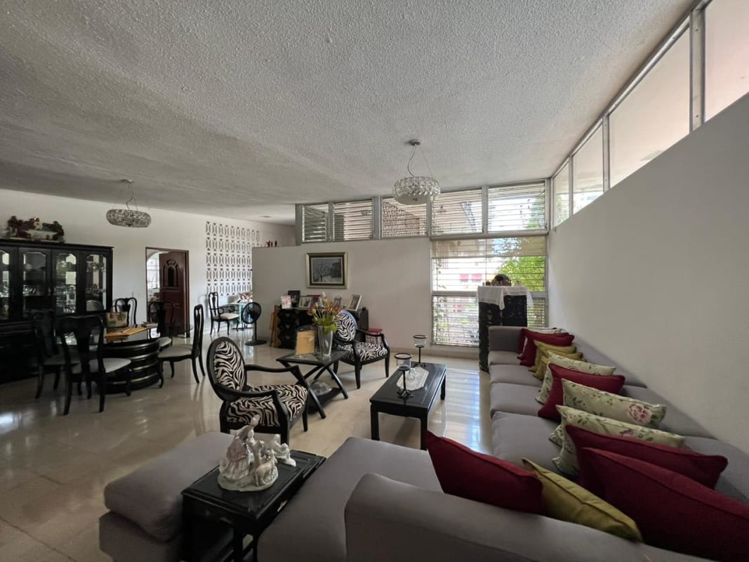 Large living dining room with mid-century décor and windows in Bella Vista El Carmen house sale