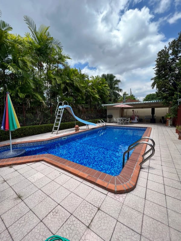 Urban residential exterior with garden walkway and trees Bella Vista Panama house for sale