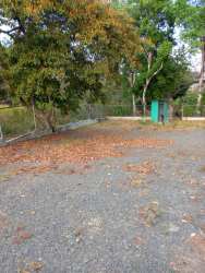 Vacant filled land with green utility shed for sale San Carlos Coclé