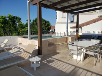 Outdoor terrace with seating area overlooking tropical gardens at Buenaventura Panama