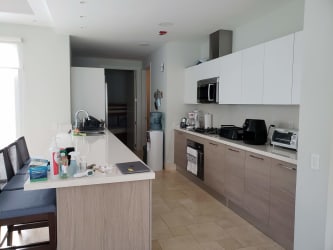 Rooftop pool deck with pergola, lounge chairs and ocean views at Buenaventura Panama