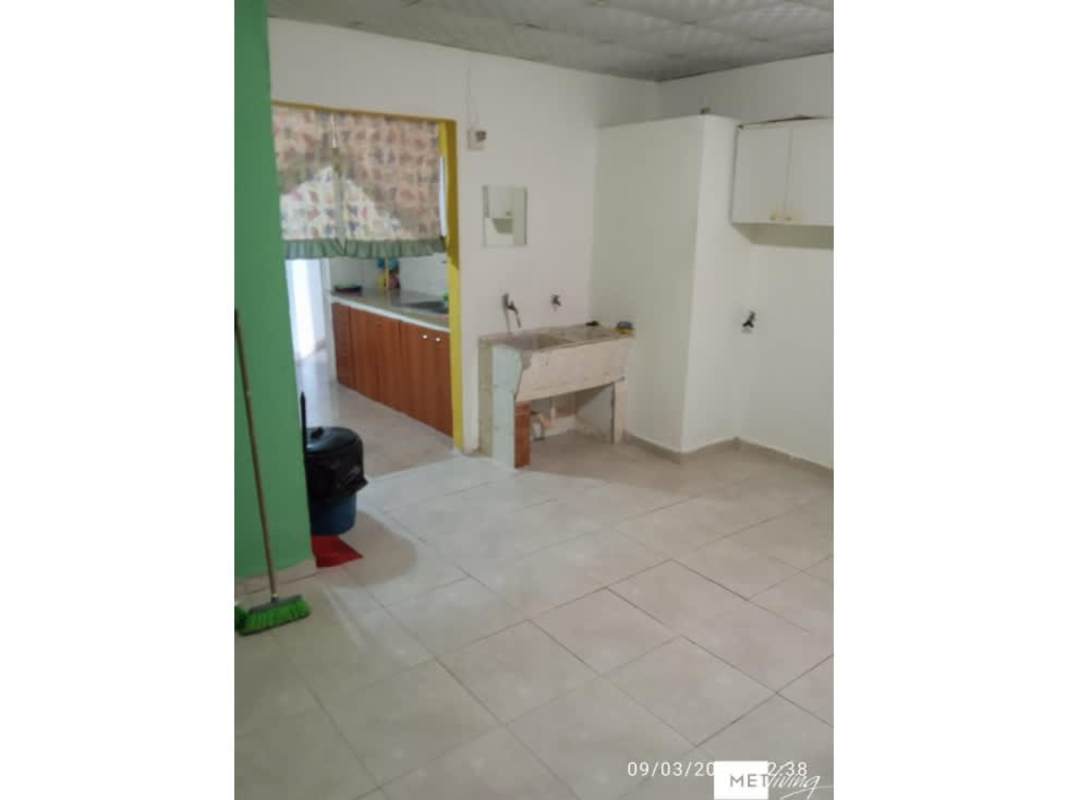 Compact kitchen with granite countertop, white cabinets in house at Altos del Crisol Panama