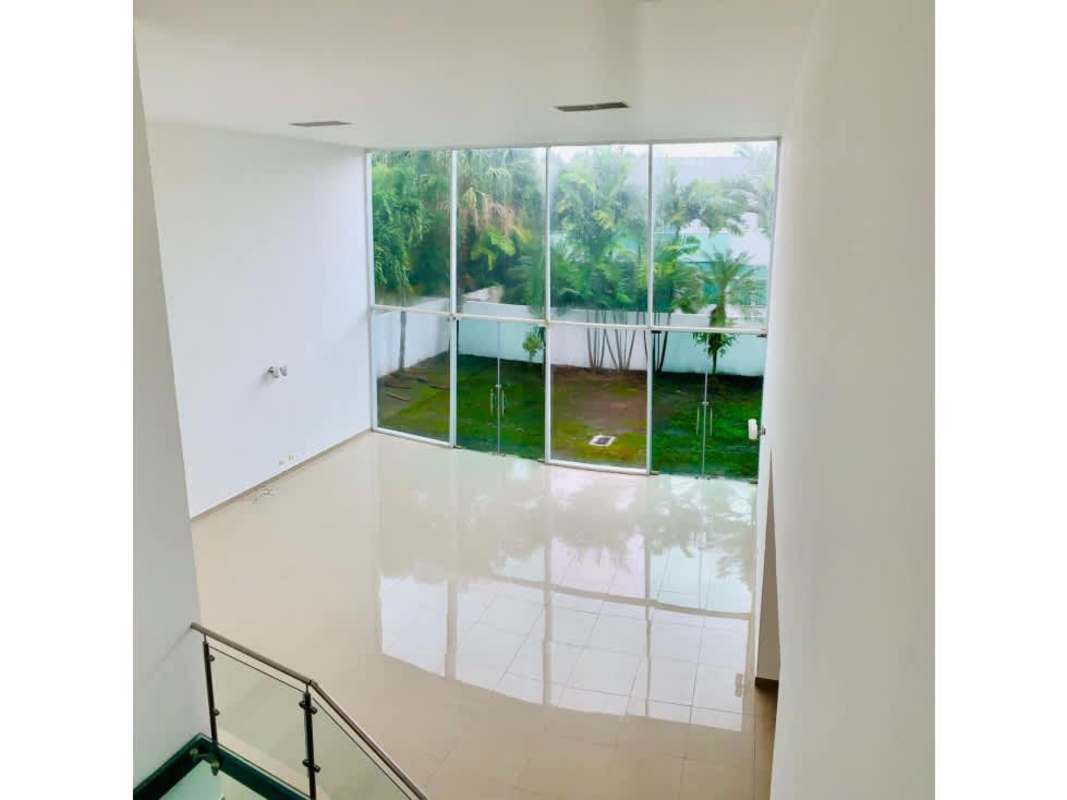 Spacious walk-in closet with wooden shelving and adjacent bathroom in PH Costa Esmeralda Panama