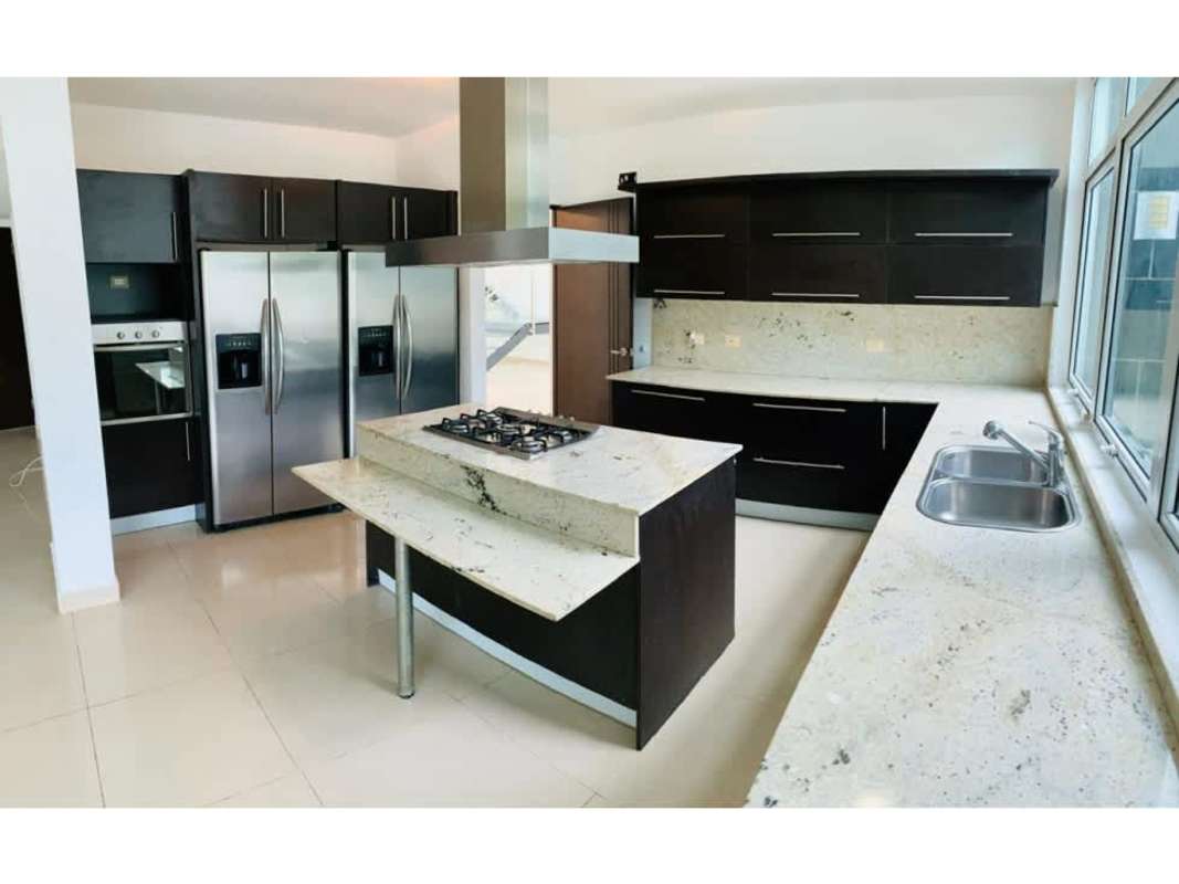 Modern kitchen with granite counters, island stove, stainless fridge PH Costa Esmeralda Panama City