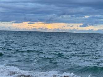 Covered balcony with seating overlooking ocean and lagoon Playa Blanca Panama rental