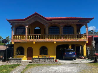 Two-story Mediterranean style house with arched windows and balcony Volcán Panama