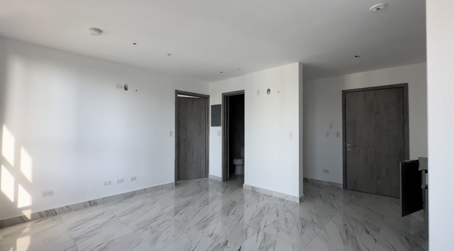 Living-dining space with marble tile floors and large windows showing Panama skyline