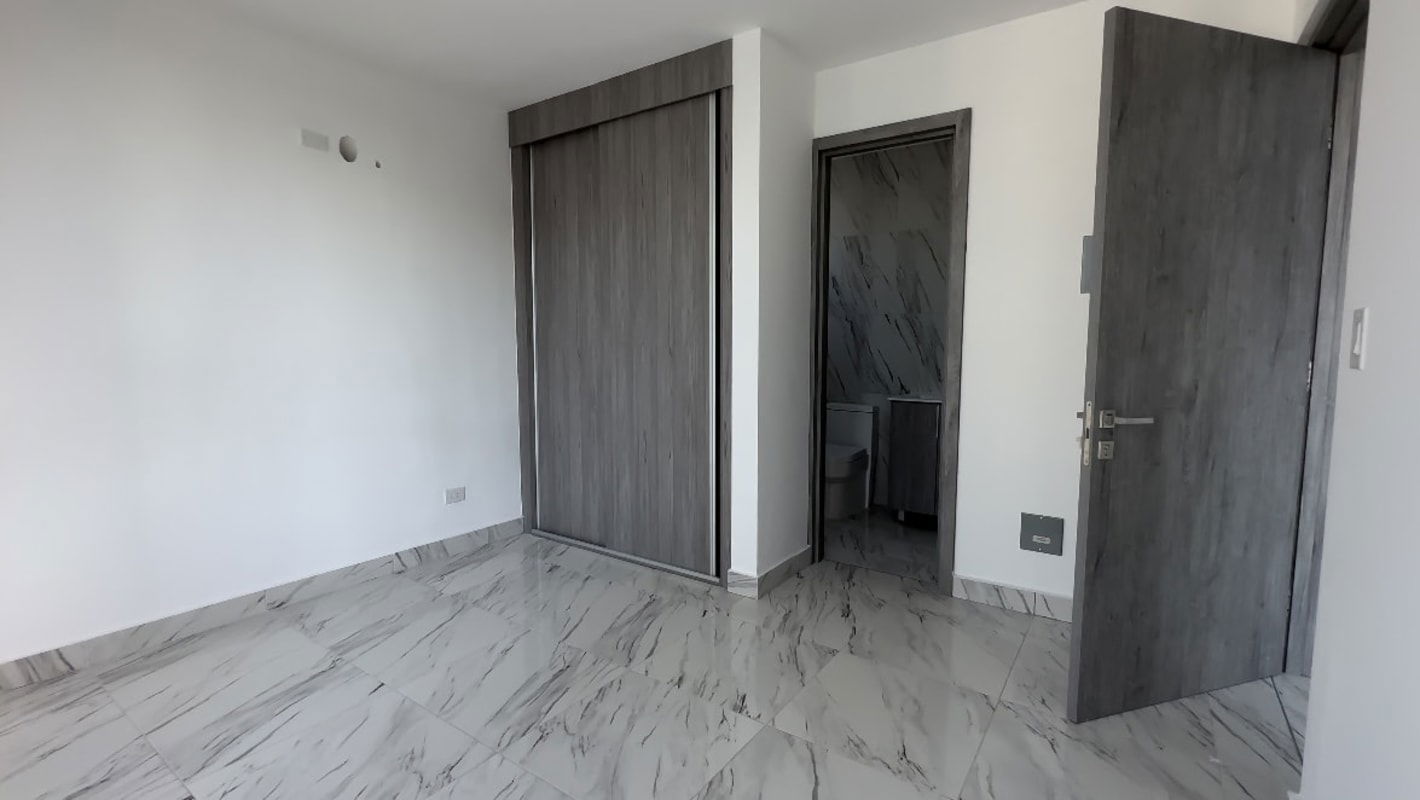 Bedroom featuring marble floor, large window with skyline views in PH The Gray Panama City