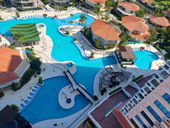 Aerial view of lagoon pools, gazebo, bridges at Coronado Country Club beachfront condo Punta Chame
