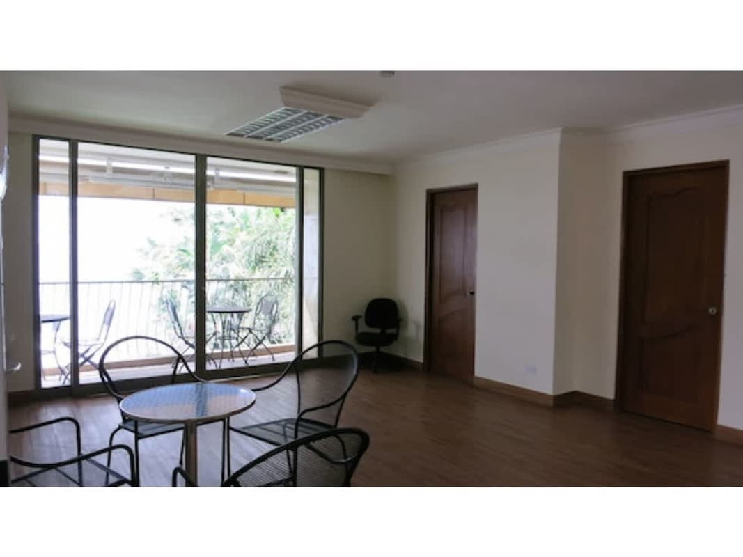 Versatile living or break room area with sliding glass doors to balcony in commercial house Obarrio Panama