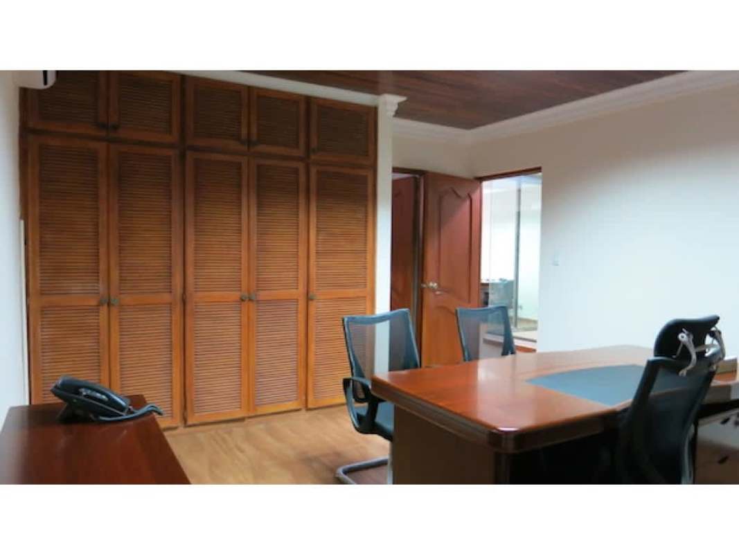 Office with wood cabinets ceiling molding and desks inside commercial house Obarrio Panama