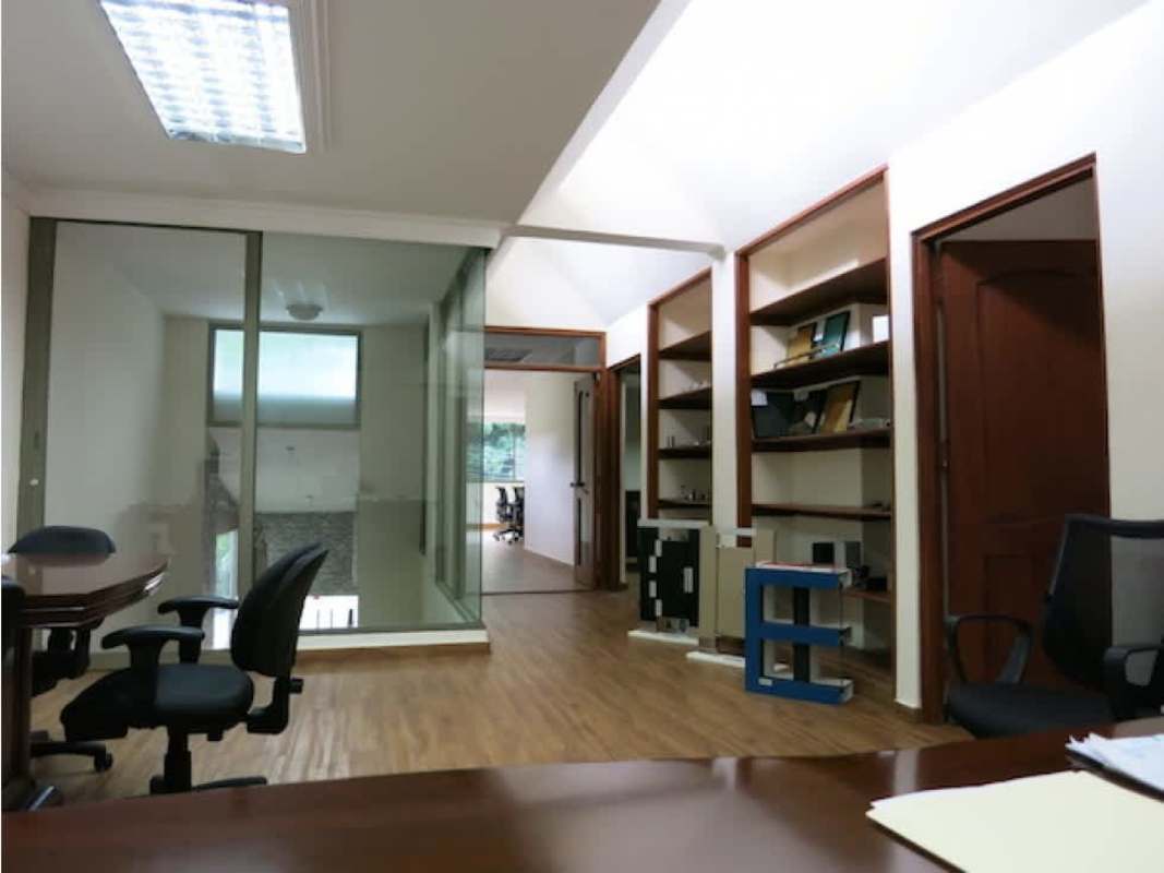 Modern glass walled meeting room with built-in shelves in Obarrio Panama commercial house