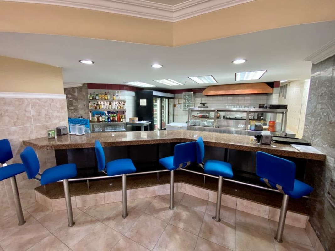 Hotel cafe bar with granite counter and blue bar stools in Panama City