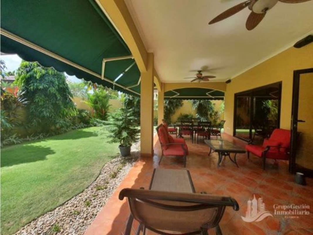 Bright living room with large windows, sofa set, ceiling fan in Costa del Este house