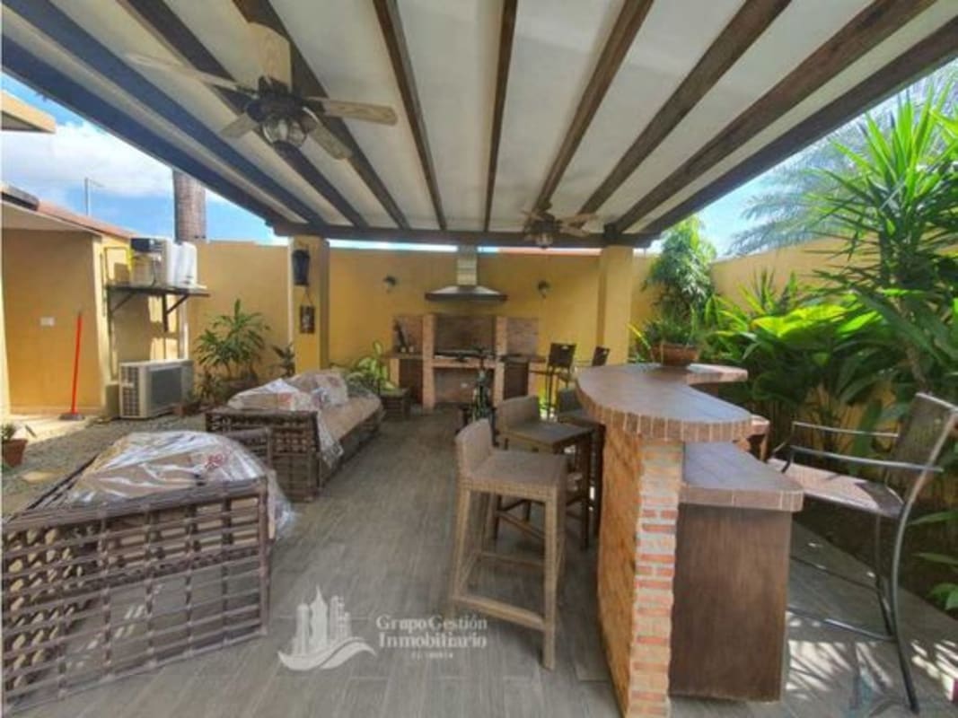 Modern informal lounge with bar, terrace access and recessed lighting