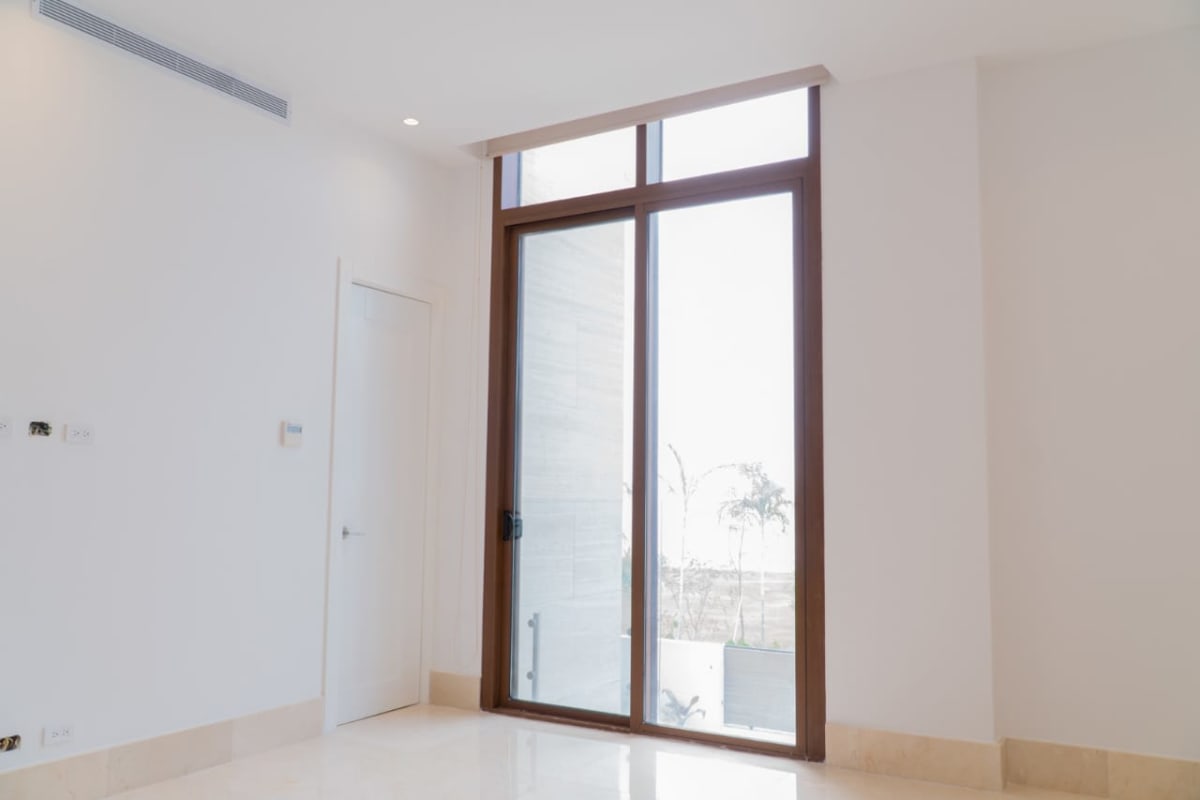 Bright luxury living room with floor-to-ceiling windows, ocean views in Ocean Reef Punta Pacifica Panama