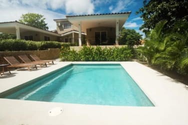 Outdoor lounge with covered terrace BBQ beside private pool in Coronado golf villa rental Panama