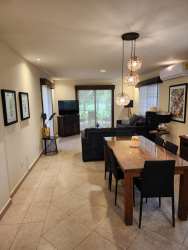 Contemporary living room with sliding doors to garden and pool in Coronado beach villa Panama