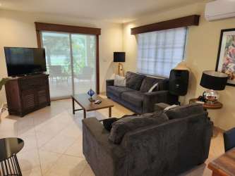 Bedroom with king bed, ensuite bath, tropical decor in luxury Coronado rental Panama