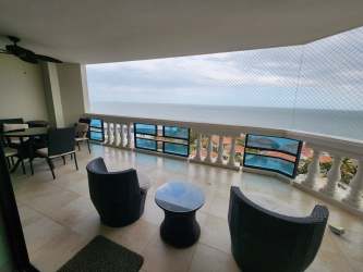 Dining area and living room with sea views and modern decor at Coronado Country Club