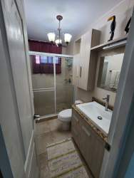 Updated bathroom with glass shower and vanity in beachfront condo Coronado