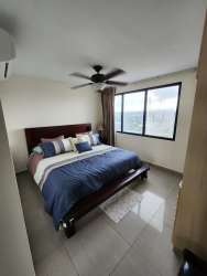 Master bedroom with large windows, balcony, and sea view at Coronado Country Club