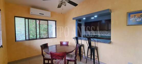 Large bedroom with windows, wood furniture, and garden view Altos del María Panama