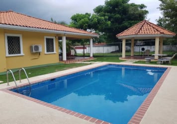 Backyard with pool, patio, and shaded gazebo in Coronado Golf house
