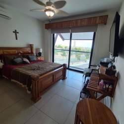 Living dining area in Casamar condo with direct ocean views and tile floors in Panama beach community