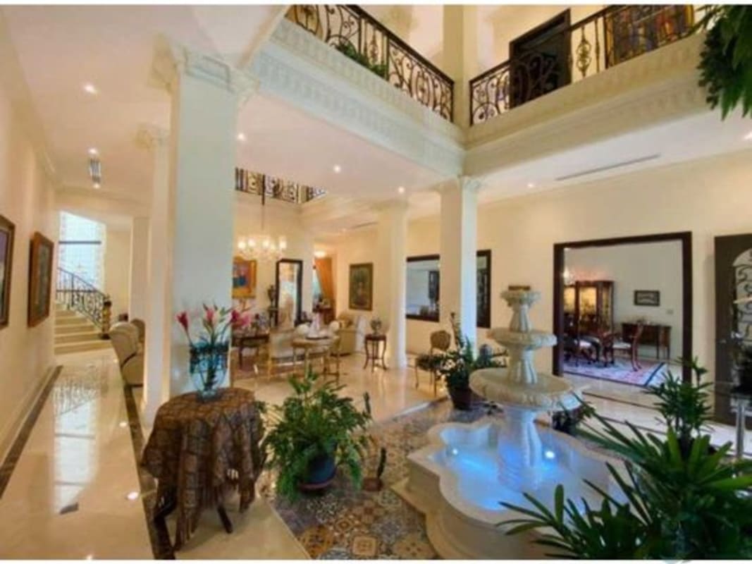 Grand Mediterranean foyer with marble floors, fountain, chandelier and columns in luxury home Santa Maria Panama