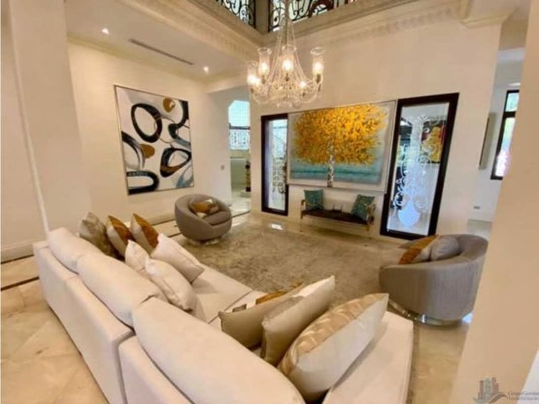 Marble floor living room with balcony railings, chandelier and luxury furnishings in Panama luxury villa