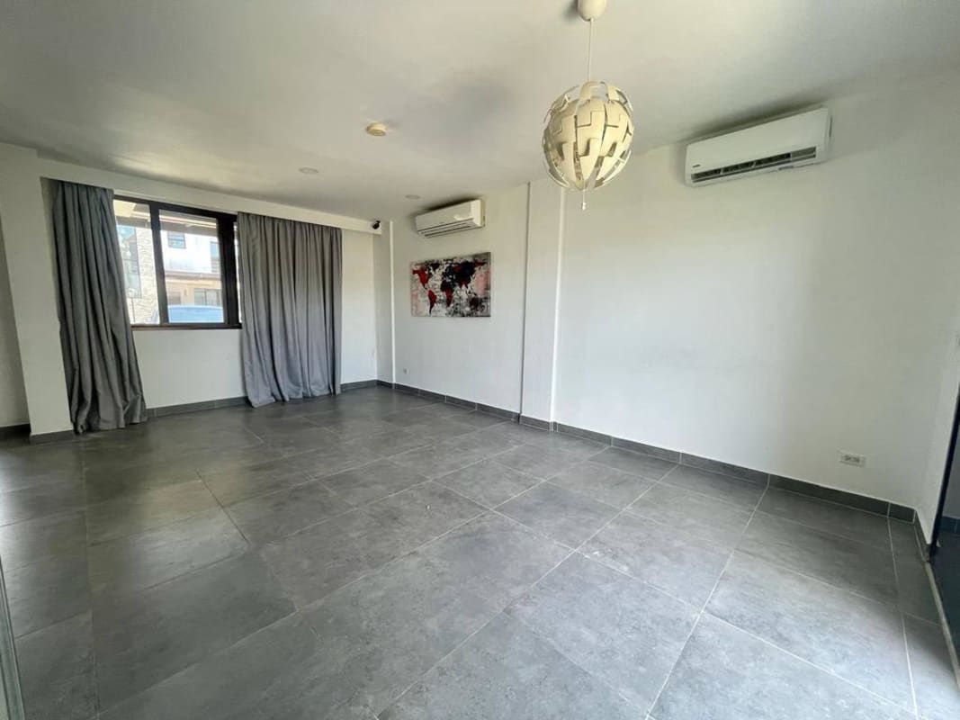 Spacious living room with AC large window curtains Costa Sur house Panama