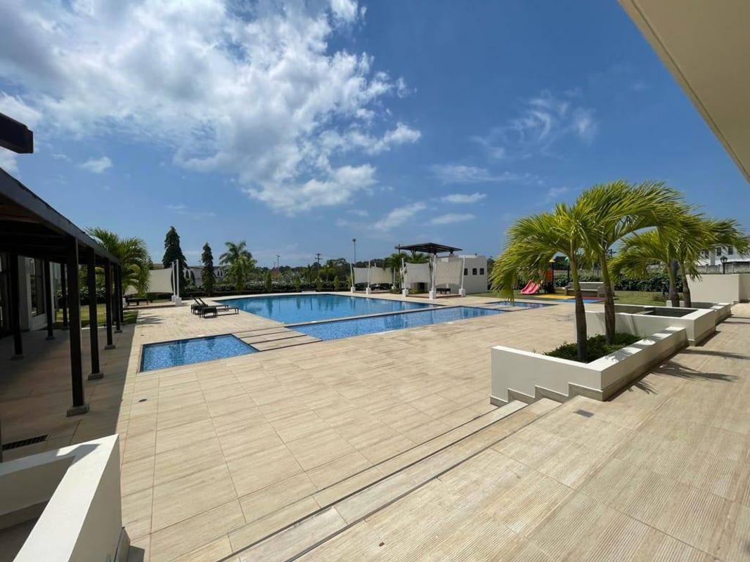 Swimming pool children playground palm trees Costa Sur community Panama
