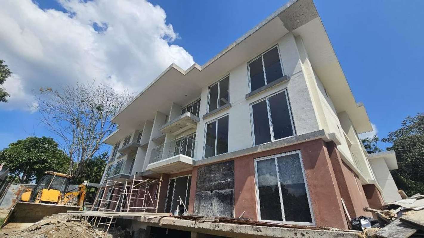 Lobby with contemporary furnishings, natural lighting, wood panel walls at PH Lux Clayton