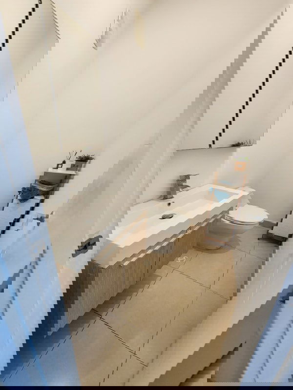 Open living and dining with panoramic ocean view windows in PH Waters on the Bay Panama City