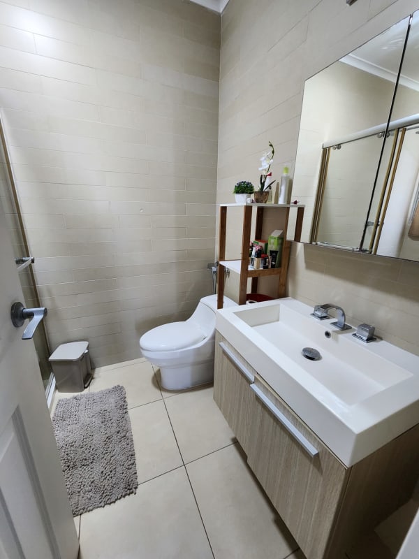 Bright kitchen with modern cabinetry, granite island, ocean skyline view in PH Waters on the Bay Panama