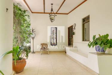 Rustic kitchen with teak wood cabinets, decorative tile, and large windows Capira Panama estate