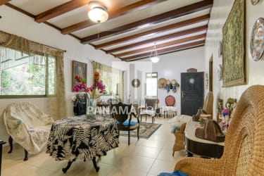 Mountain home living room with wooden beams, large window, and rustic décor in Capira Panama