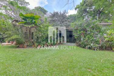 Spacious lawn with fruit trees, mature landscaping, and garden paths in countryside Capira Panama