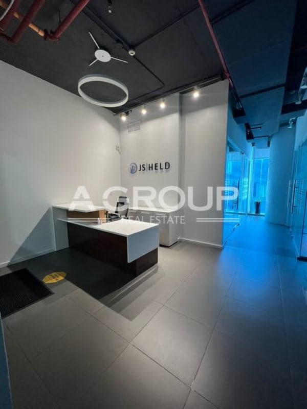 Reception area with minimalistic desk, glass partitions at Oceania Tower 100