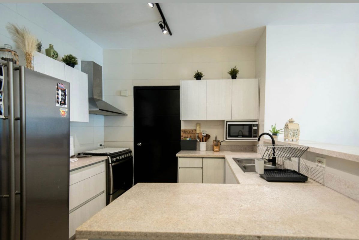 Bright kitchen with quartz countertops, stainless steel appliances in PH Ocean View Tower San Francisco Panama City