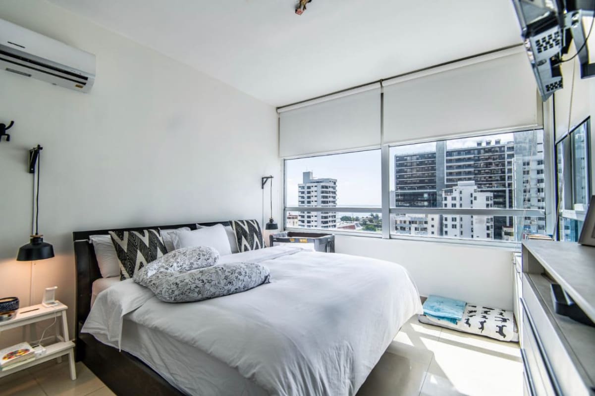 Spacious living room with large windows and balcony ocean views in PH Ocean View Tower San Francisco