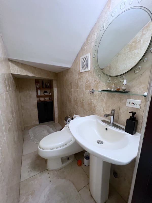 Spacious penthouse living room with large sliding glass doors to terrace PH Portofino Panama