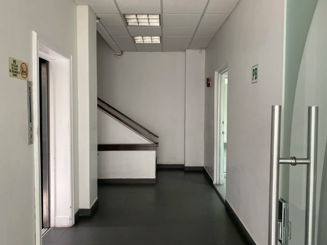 Corner commercial plaza building with glass storefront and signage on Via España Panama City