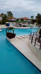 Coastal style master bedroom with balcony access in Coronado beachfront apartment Panama