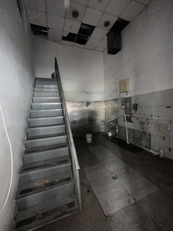 Basic bathroom with blue wall, white tiles, urinal, toilet in Boulevard Plaza commercial property