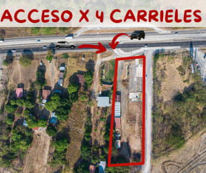 Commercial land bordering the Pan-American Highway with parked vehicles and signage in Chame Coronado Panama