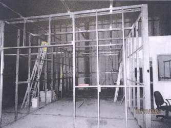 Partitioned office inside industrial building with mezzanine and metal stairs El Espinal Panama