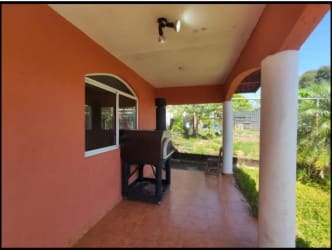 Covered Mediterranean patio area with oven and tiled floor on highway-front Chame property Panama