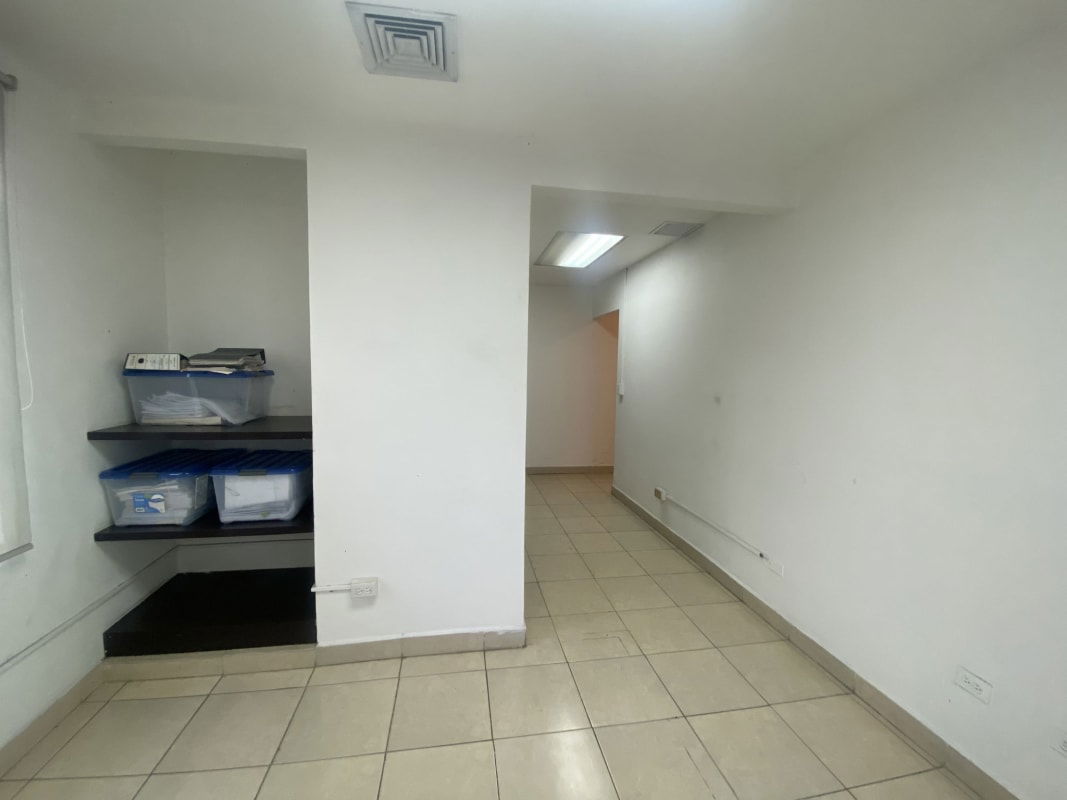 Small storage or office room with built-in dark shelves, tile floors in PH Bella Vista Tower Panama